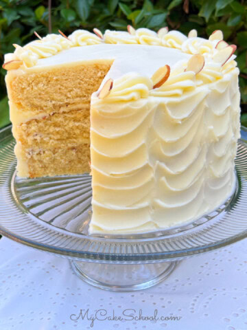 Maple Almond Cake, sliced, on a cake pedestal.