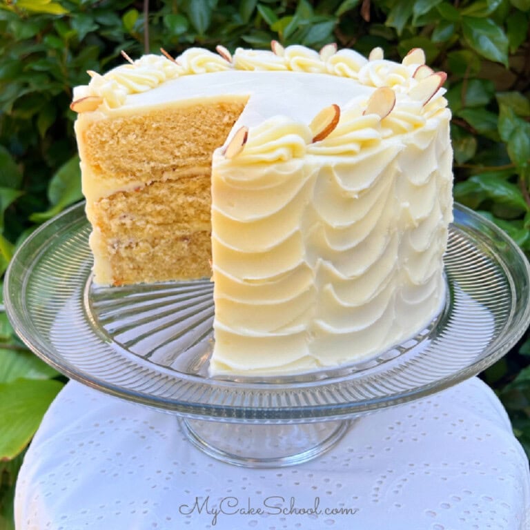 Maple Almond Cake, sliced, on a cake pedestal.