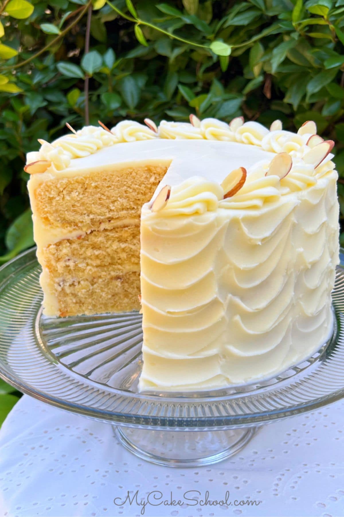 Maple Almond Cake, sliced, on a cake pedestal.