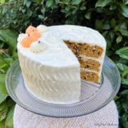 Pumpkin Chocolate Chip Cake, sliced, on a cake pedestal.