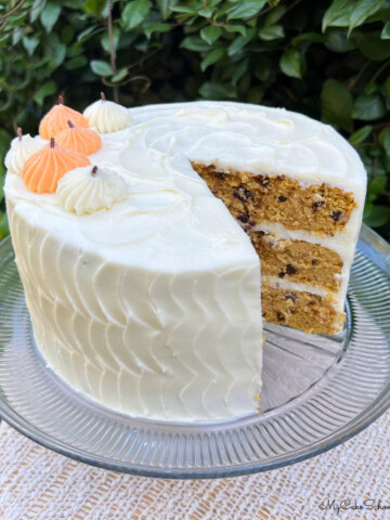 Pumpkin Chocolate Chip Cake, sliced, on a cake pedestal.