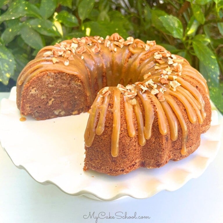 Apple Dapple Cake on a white pedestal.