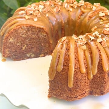 Apple Dapple Cake on a white pedestal.