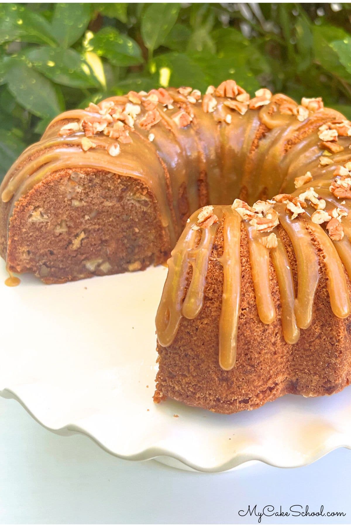 Apple Dapple Cake on a white pedestal.