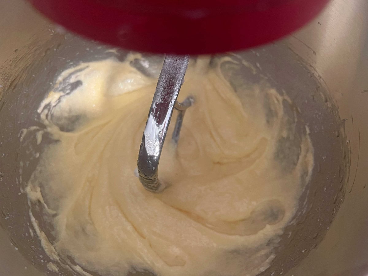 Mixing batter after adding the eggs into the sugar and butter.