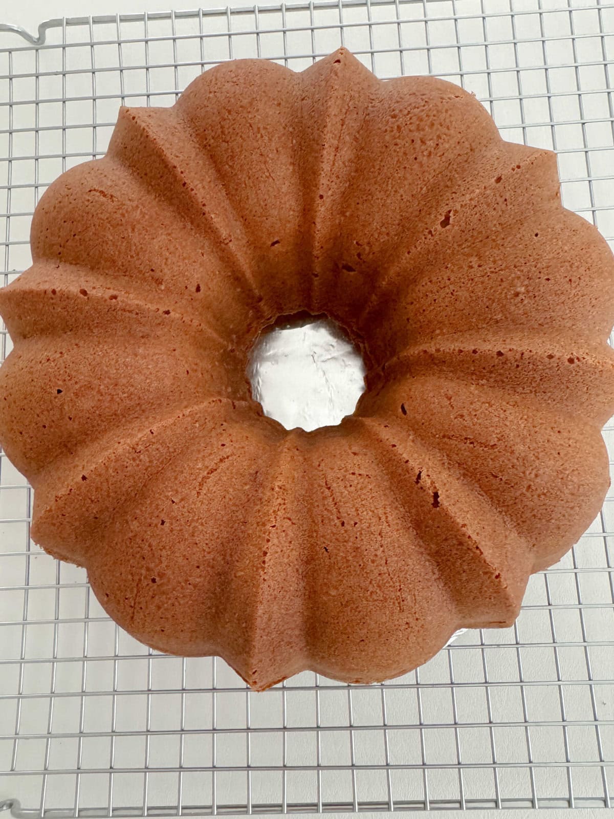 Orange Coconut Pound Cake, cooling, on a wire rack.