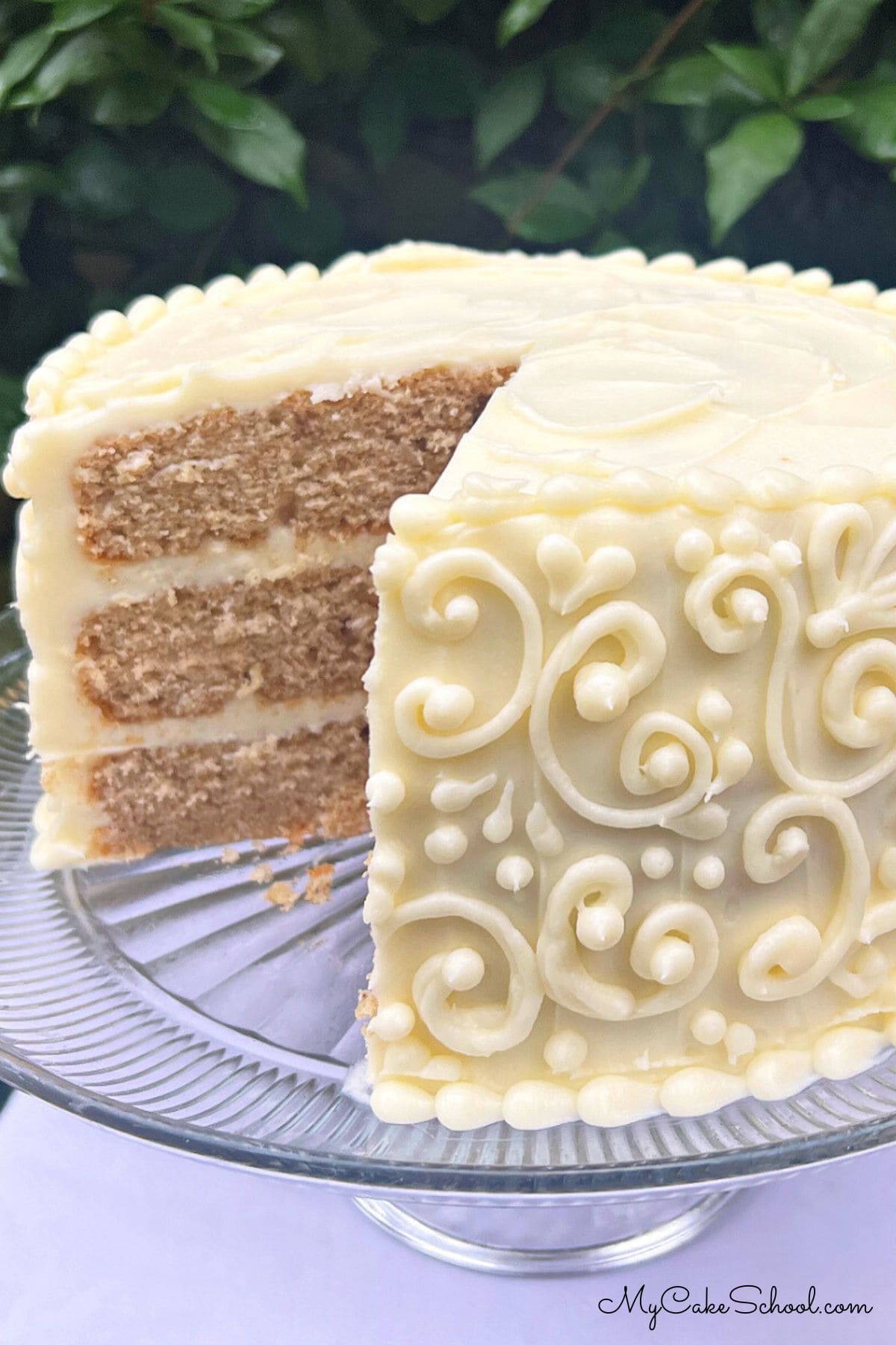 Chai Cake, sliced, on a cake pedestal.