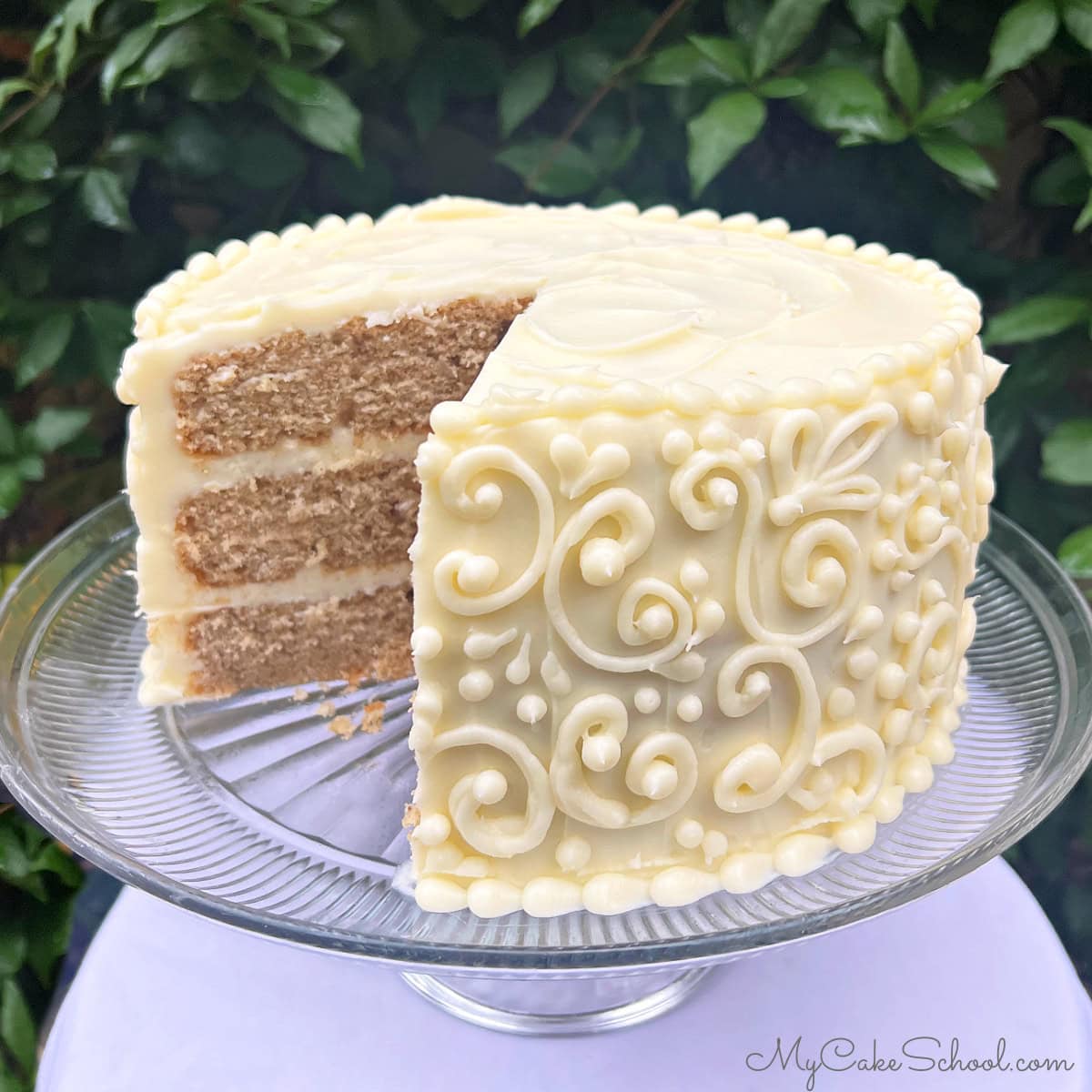 Chai Cake, sliced, on a cake pedestal.