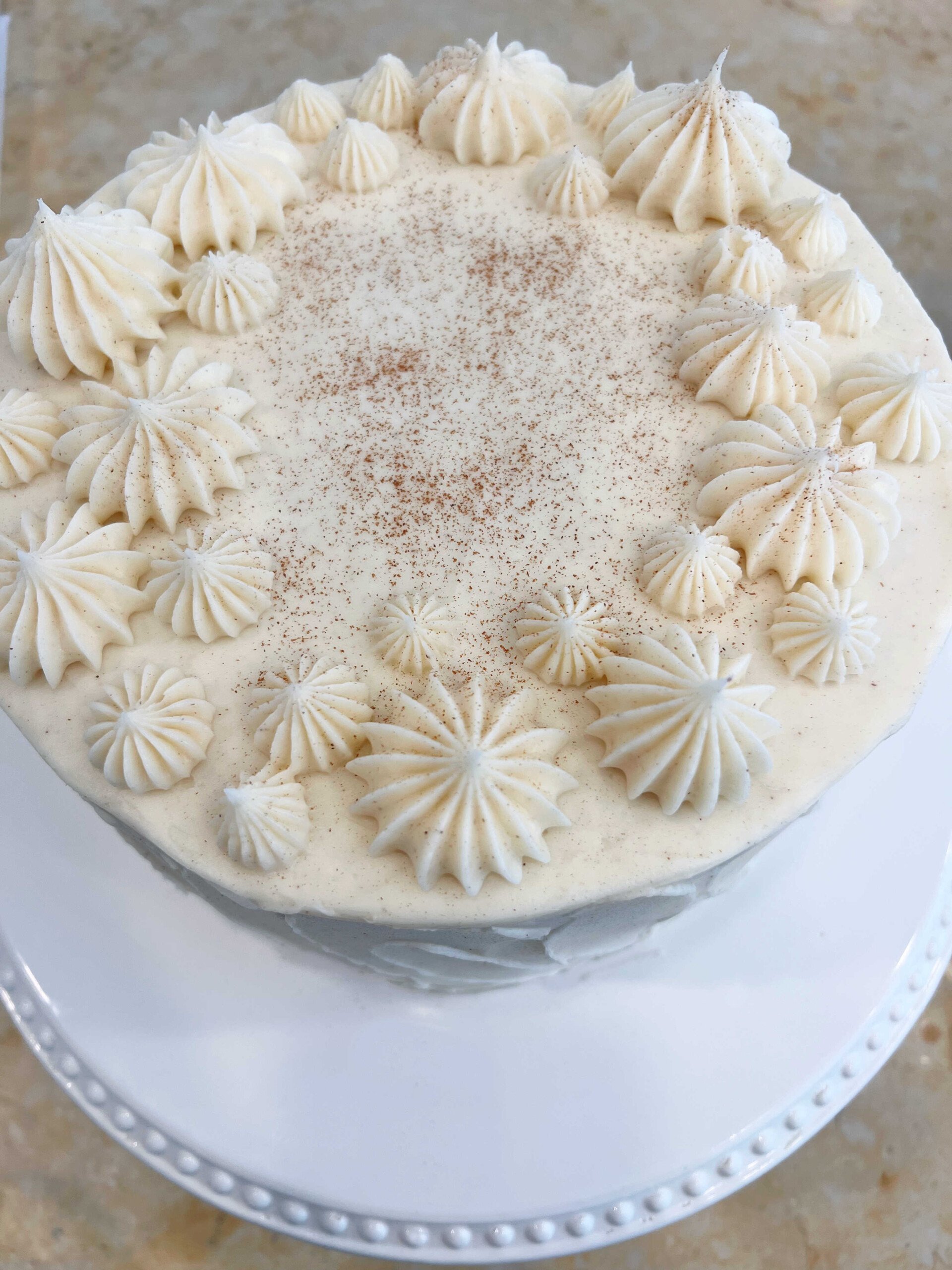 Top view of cinnamon cake with cinnamon piping on top.