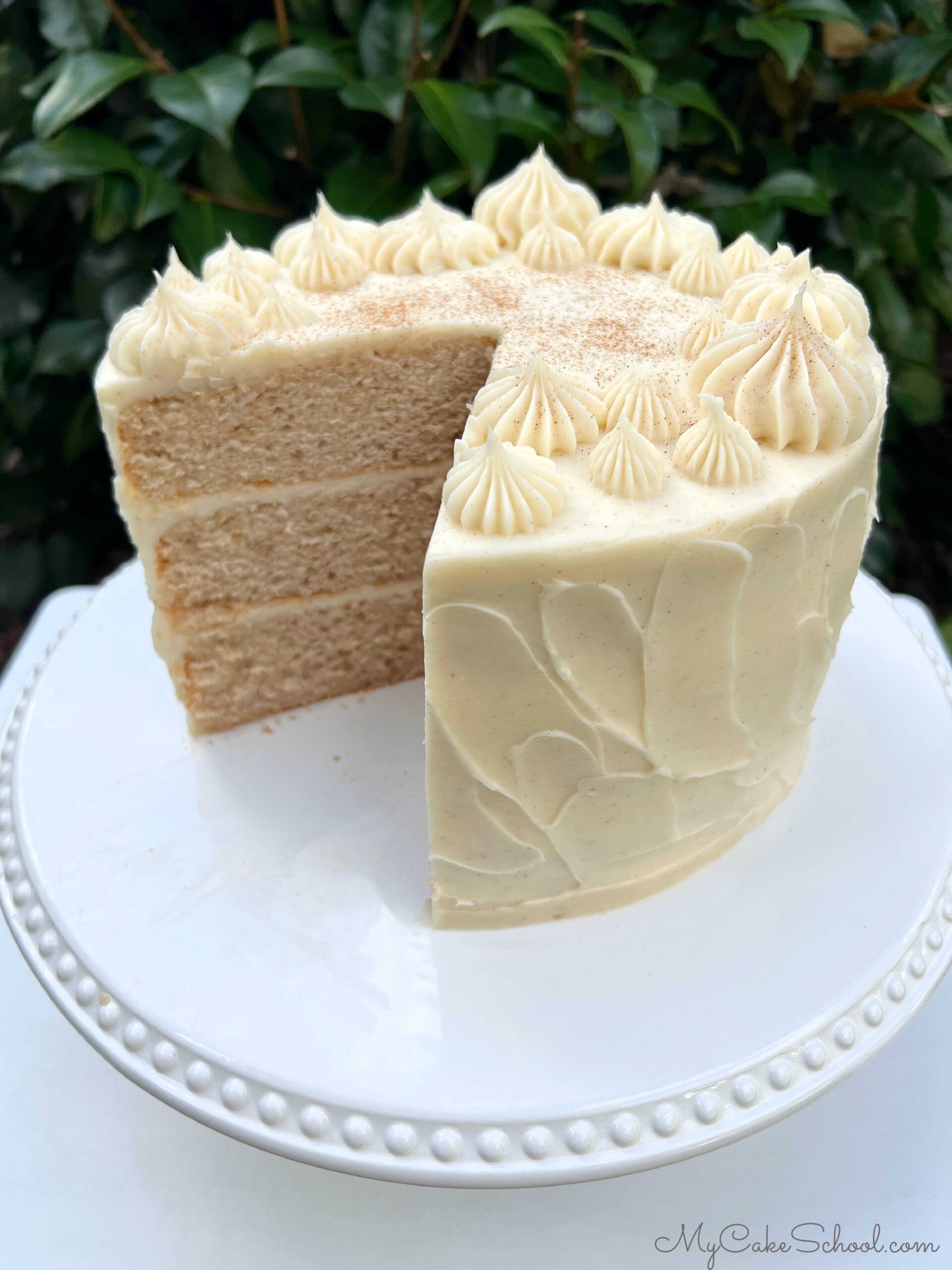 Cinnamon Cake, sliced, on cake pedestal.