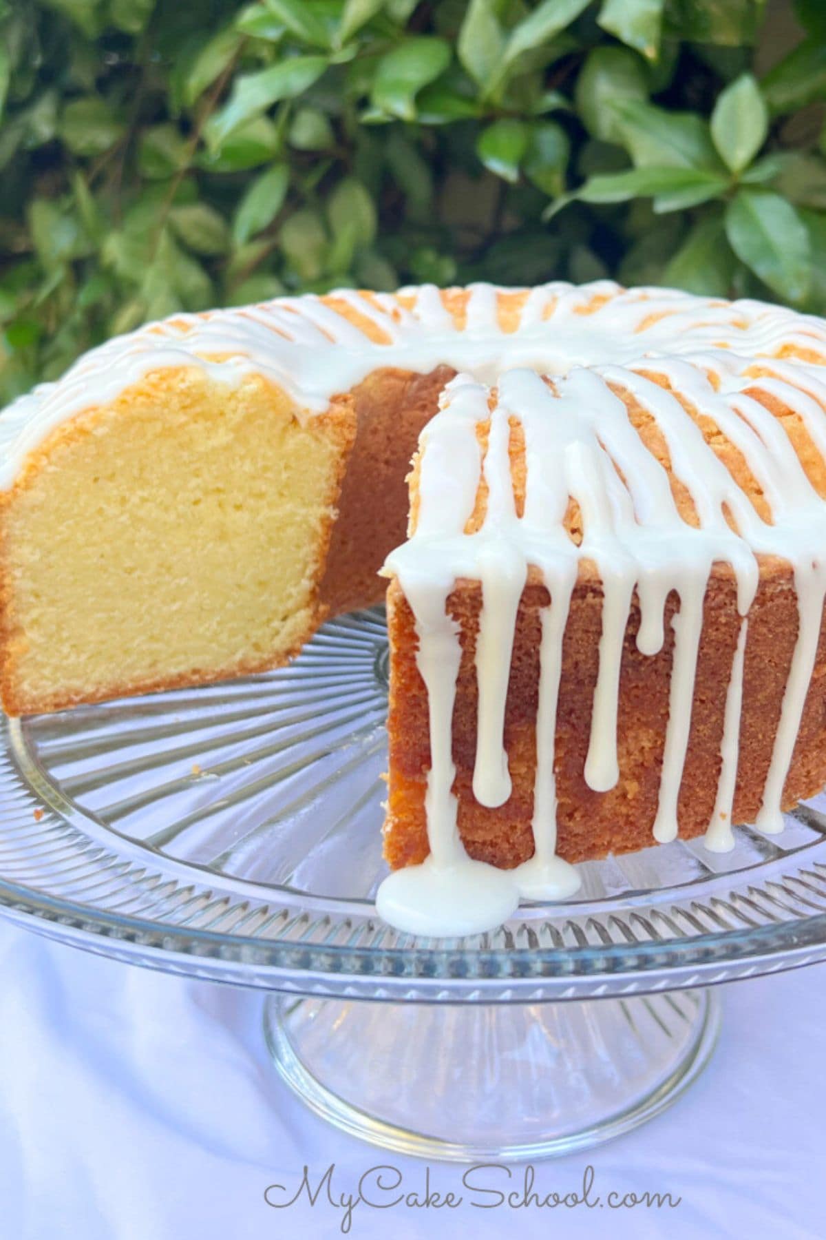 Mascarpone Pound Cake, sliced, on a cake pedestal.