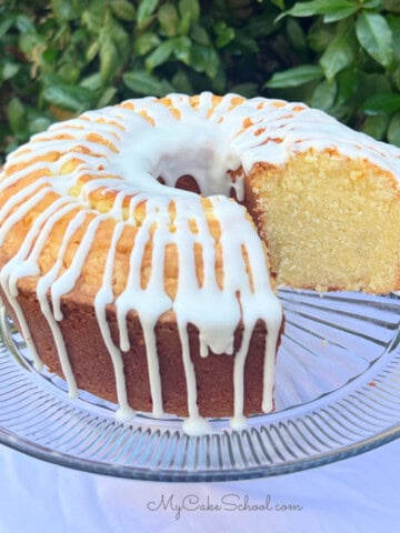 Mascarpone Pound Cake, sliced, on a cake pedestal.