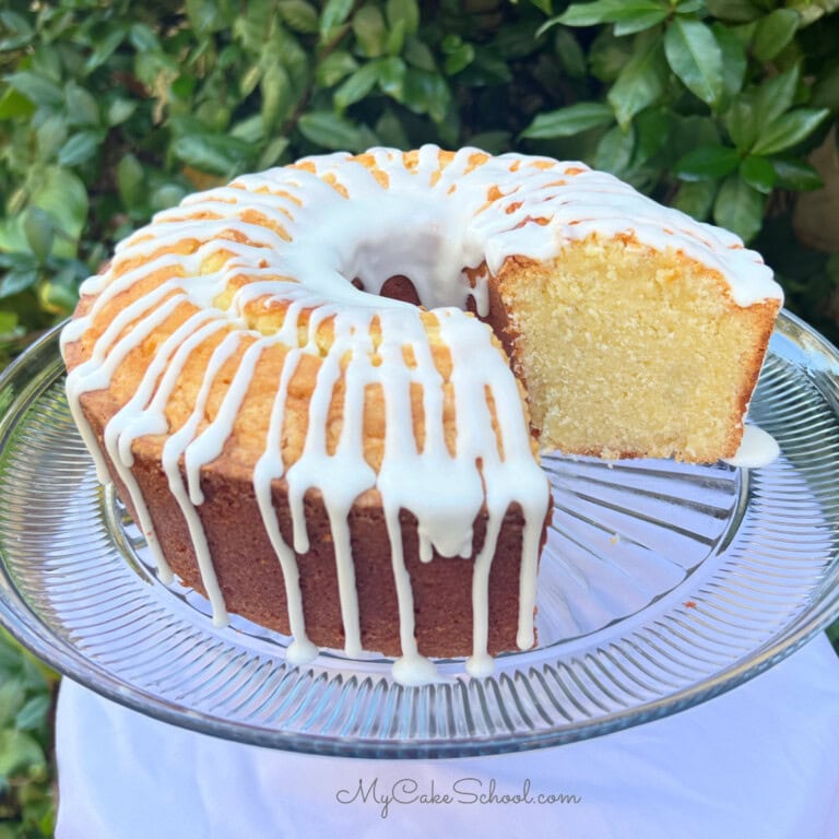 Mascarpone Pound Cake, sliced, on a cake pedestal.