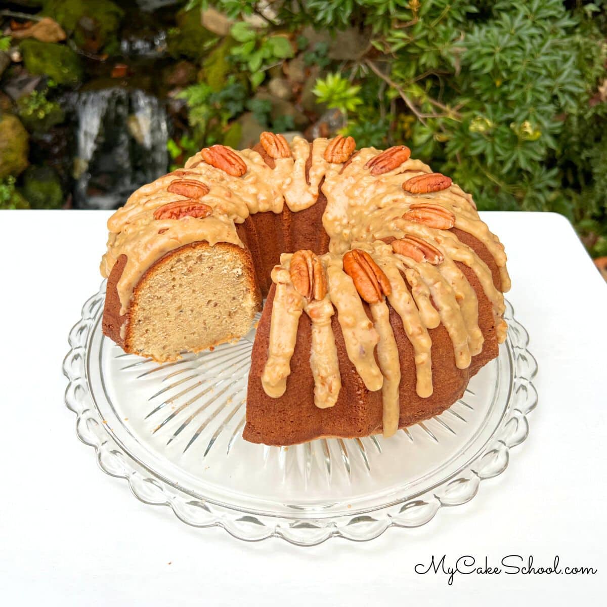 Praline Pound Cake, sliced, on a cake pedestal.