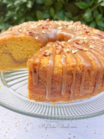 Pumpkin Snickerdoodle Bundt Cake, sliced, on a cake pedestal.