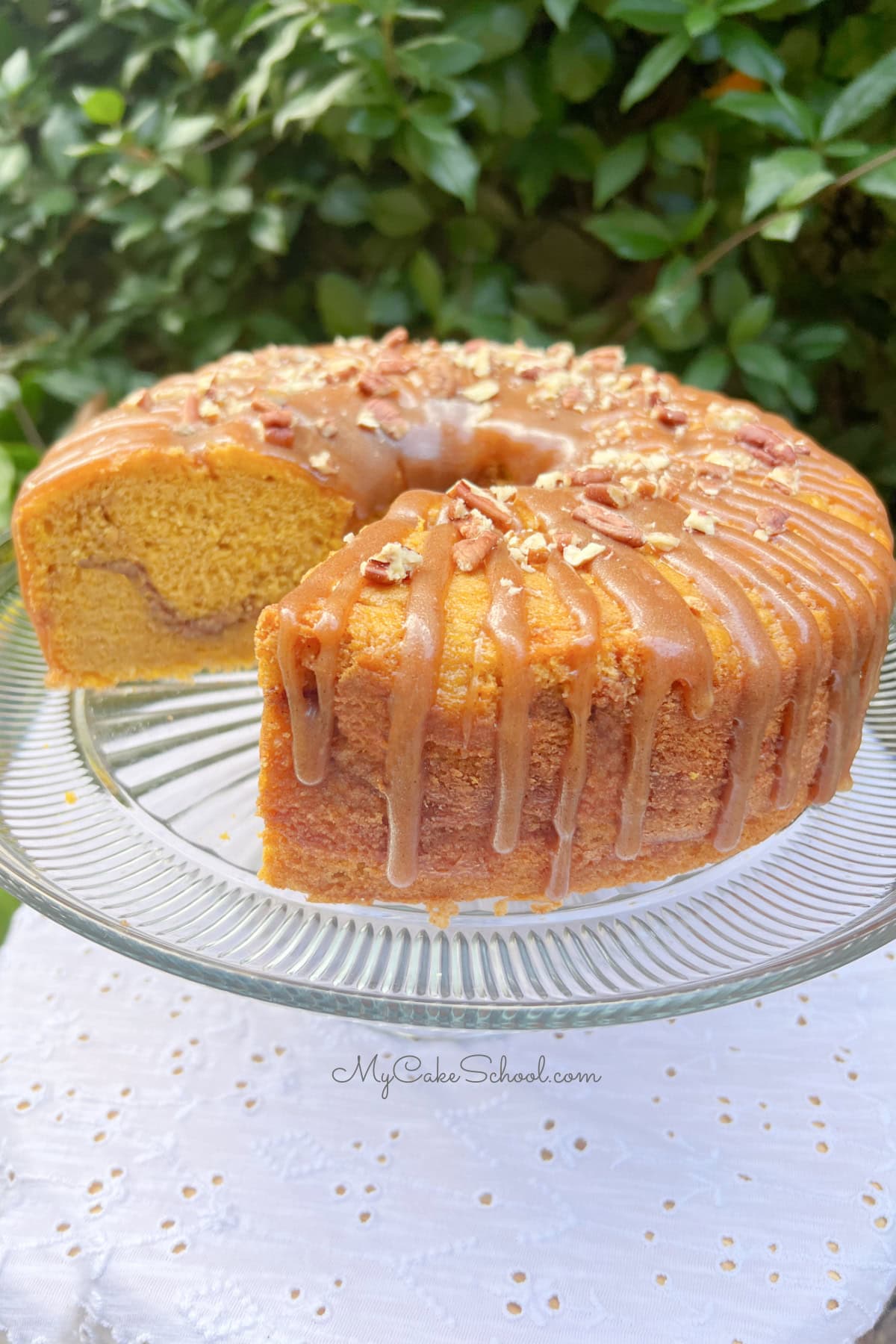 Pumpkin Snickerdoodle Bundt Cake, sliced, on a pedestal.