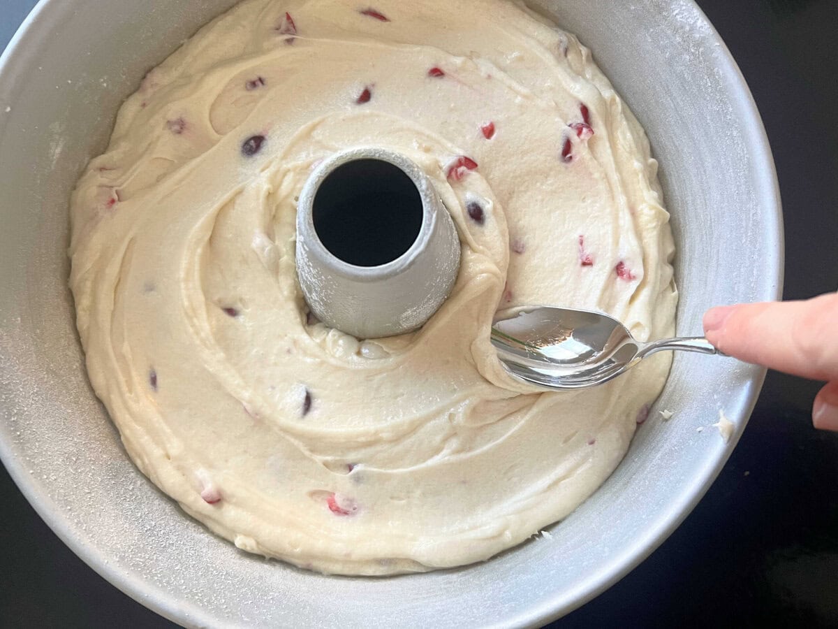 Filling the tube pan with batter.