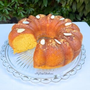 Sliced Almond Rum Cake on a cake pedestal.