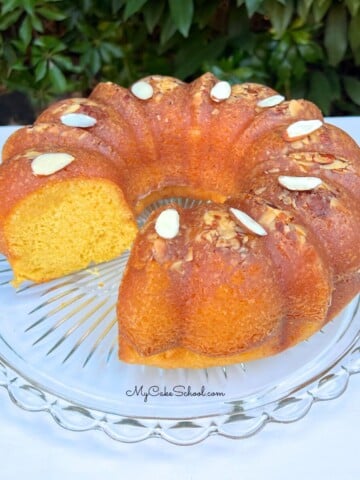 Sliced Almond Rum Cake on a cake pedestal.