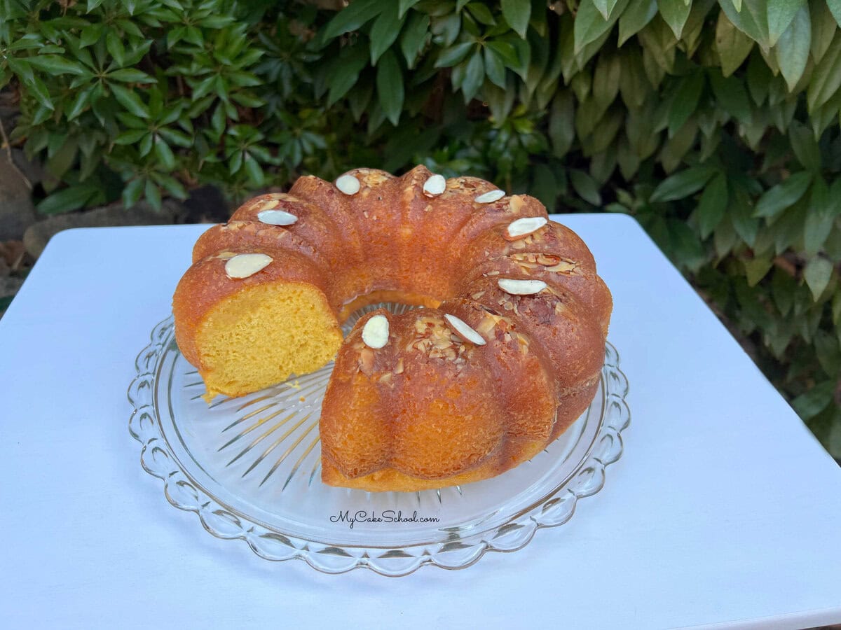 Almond Rum Cake, sliced, on a cake plate.