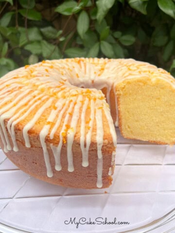 Orange Pound Cake, sliced, on a cake plate.