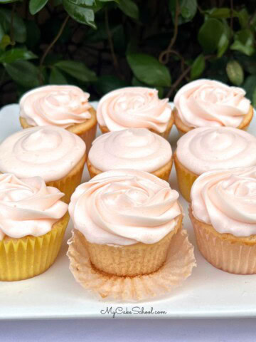 Pink Champagne Cupcakes on a cake platter.