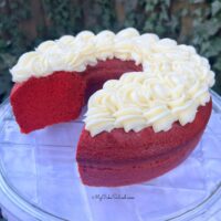 Red Velvet Bundt Cake, sliced, on a cake pedestal.