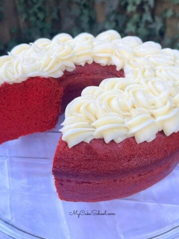 Red Velvet Bundt Cake, sliced, on a cake pedestal.