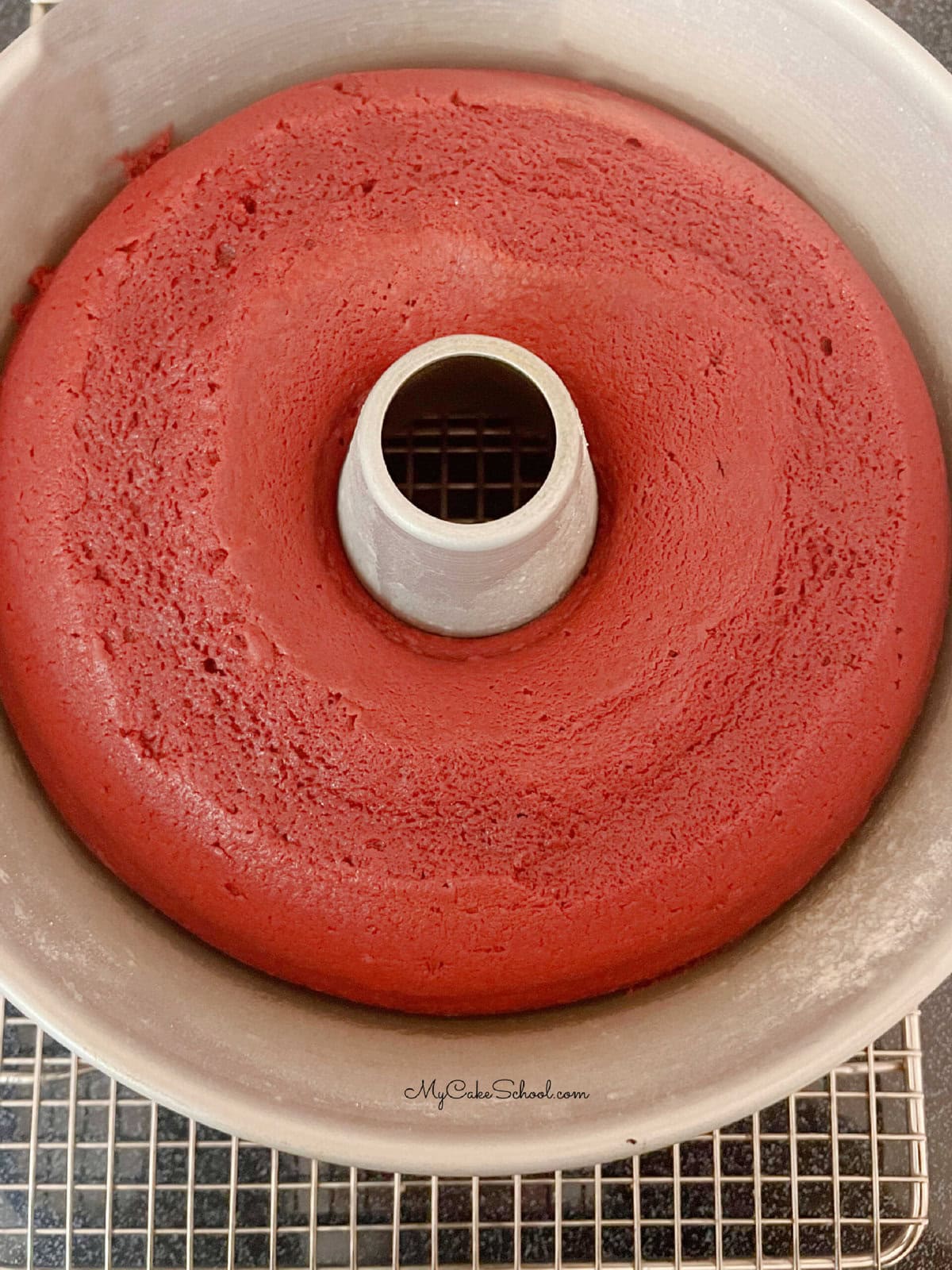 Red Velvet Bundt Cake in pan, cooling on a wire rack.