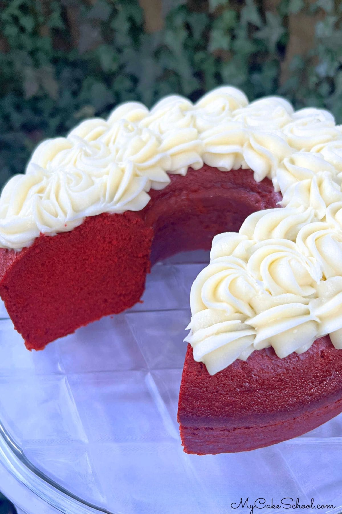 Red Velvet Bundt Cake, sliced, with cream cheese frosting.