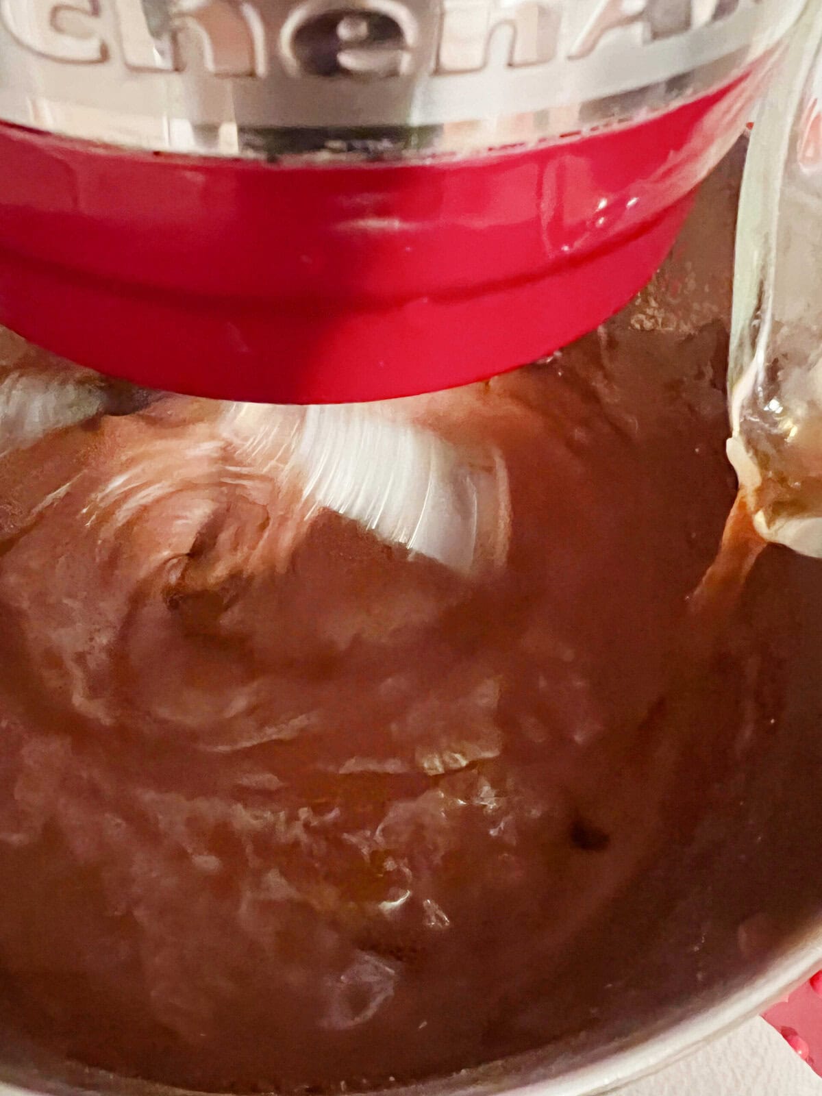 Pouring coffee into chocolate ricotta cake batter.