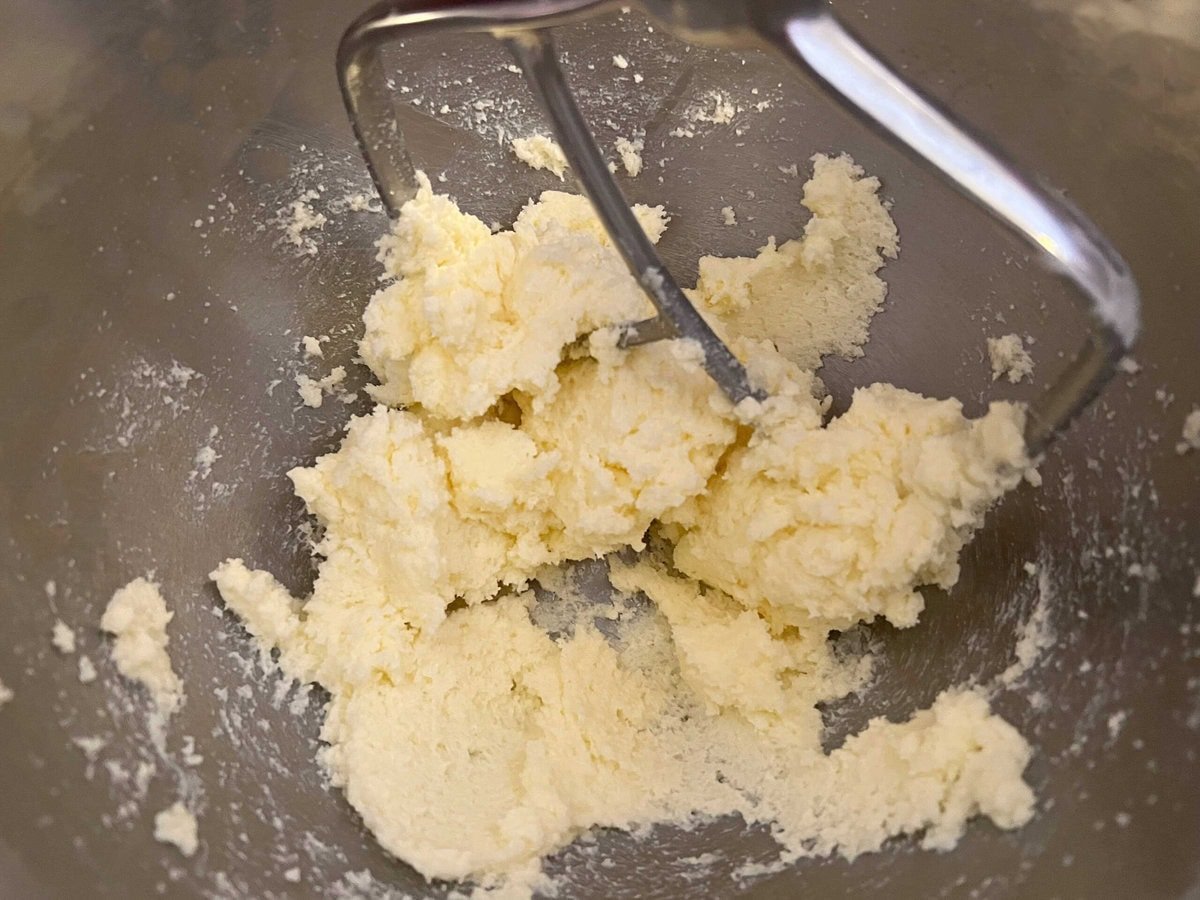 Buter and sugar in a mixing bowl.