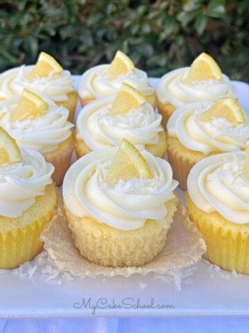 Lemon Coconut Cupcakes on a cake plate.