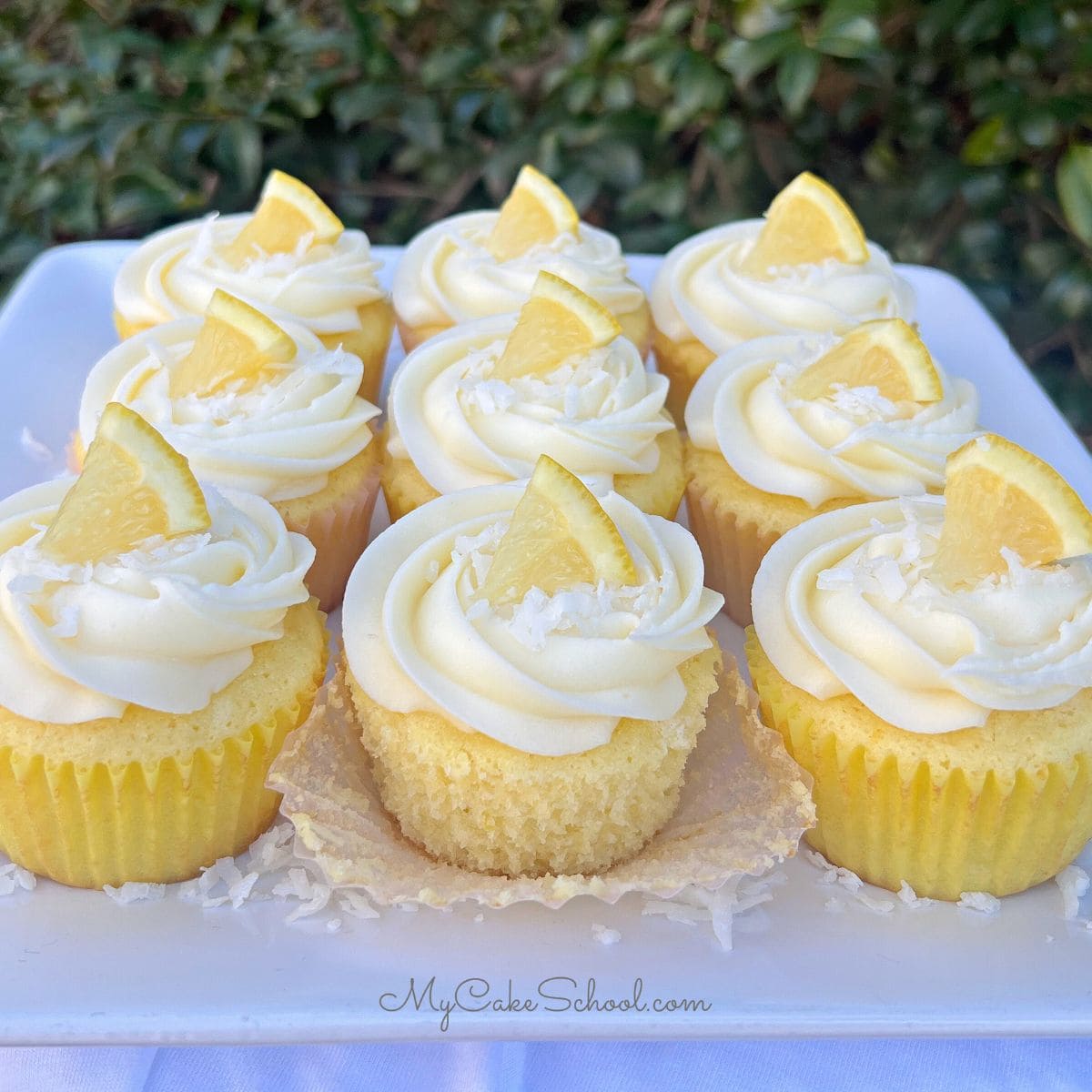 Lemon Coconut Cupcakes on a cake plate.