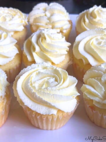 Lemon Sour Cream cupcakes on a cake platter.