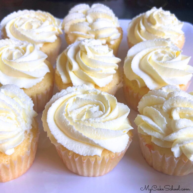 Lemon Sour Cream cupcakes on a cake platter.