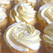 Lemon Sour Cream cupcakes on a cake plate.