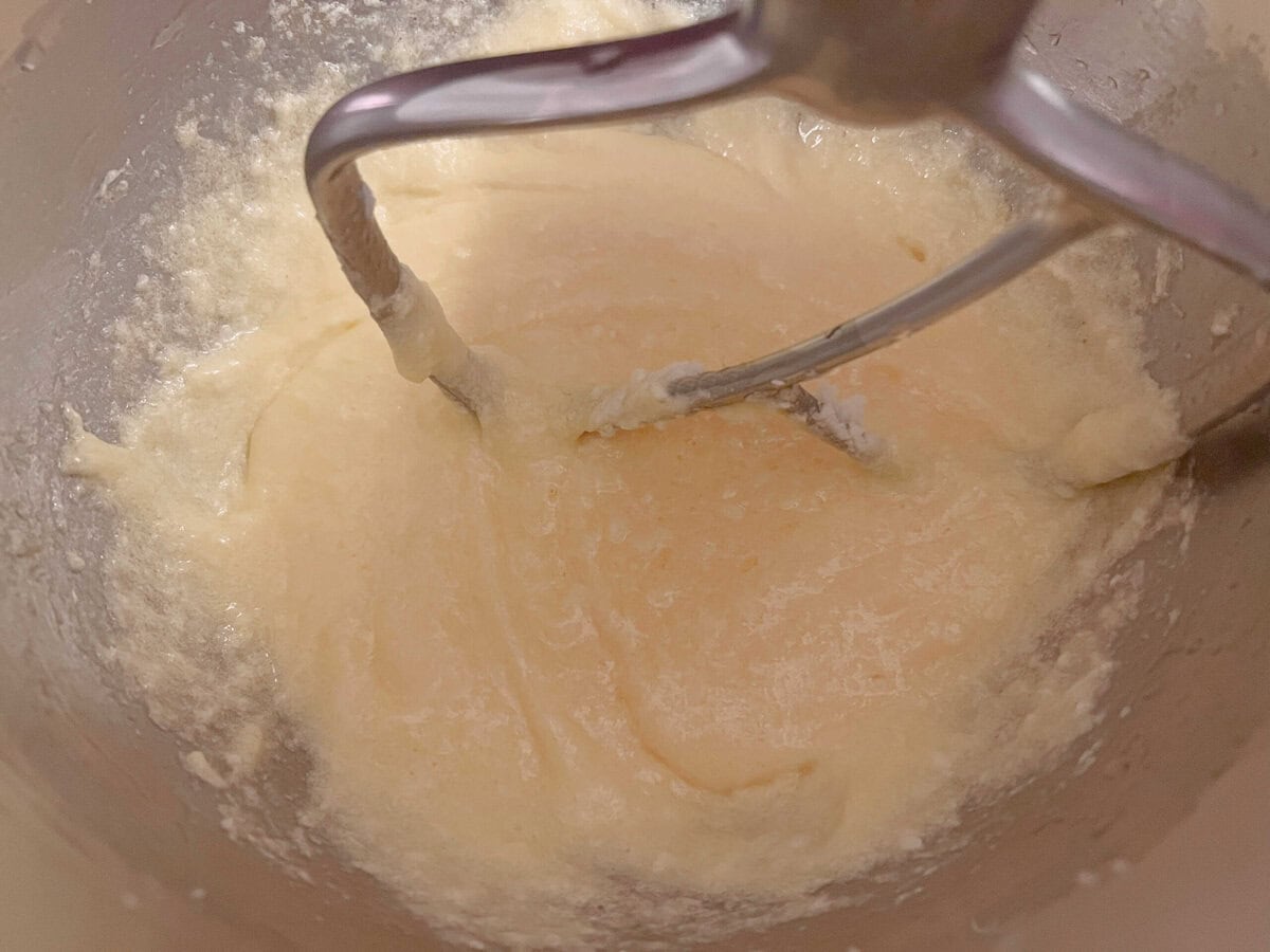 Adding eggs to the cake batter.