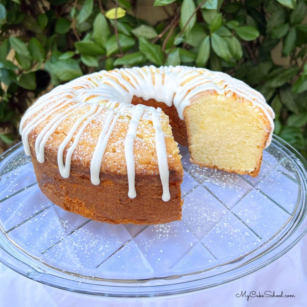 Lemon Sour Cream Pound Cake, sliced, on a cake plate.