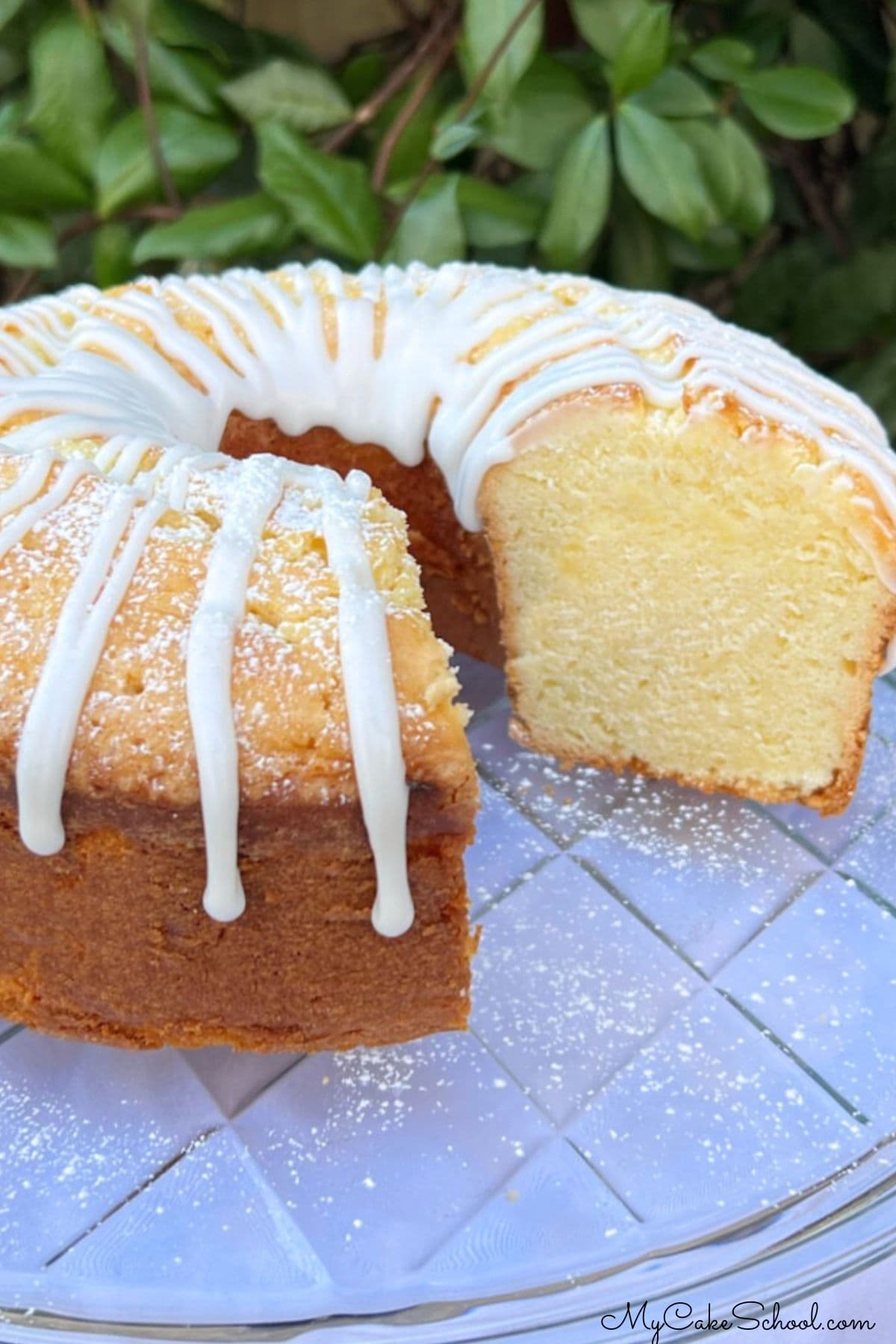 Lemon Sour Cream Pound Cake, sliced, on a cake plate.