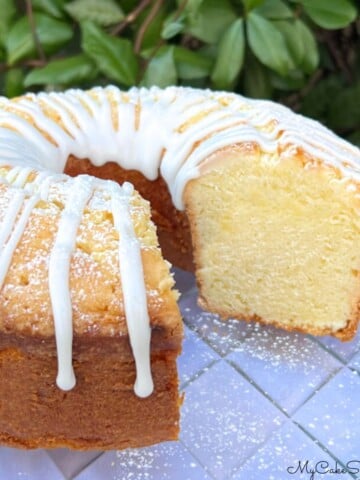 Lemon Sour Cream Pound Cake, sliced, on a cake plate.