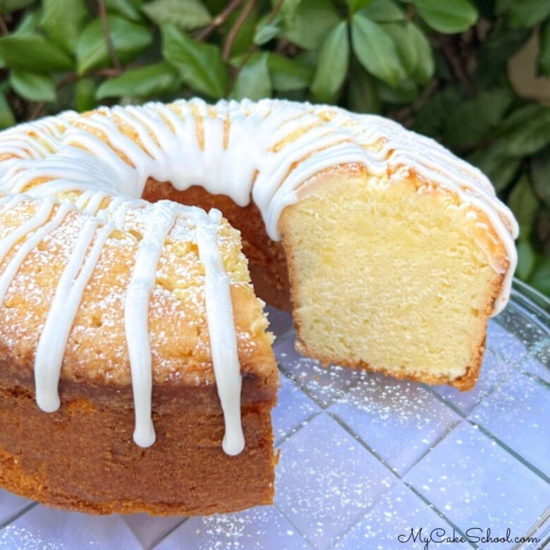 Lemon Sour Cream Pound Cake, sliced, on a cake plate.