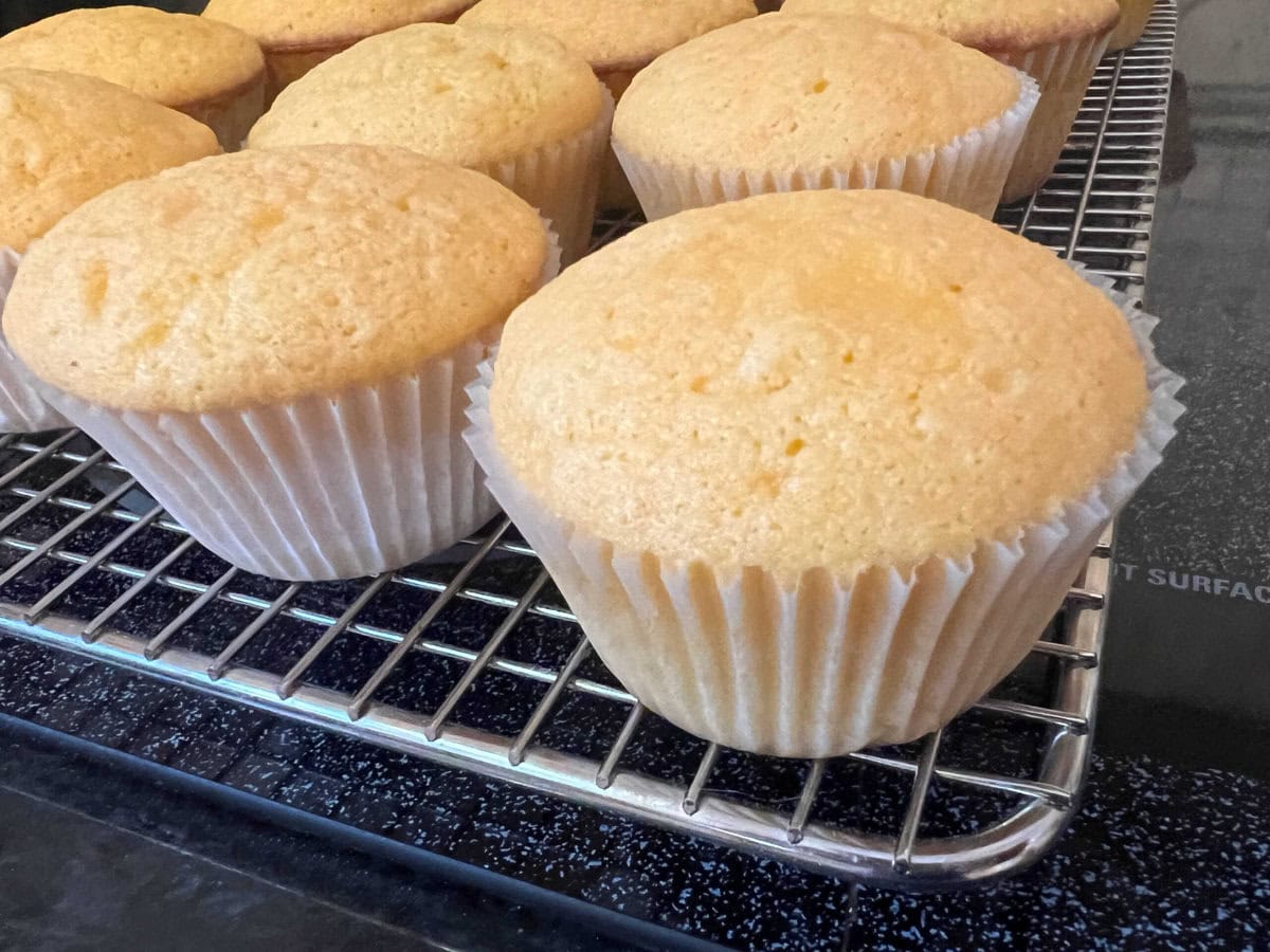 Orange Cupcakes cooling on a wire rack.