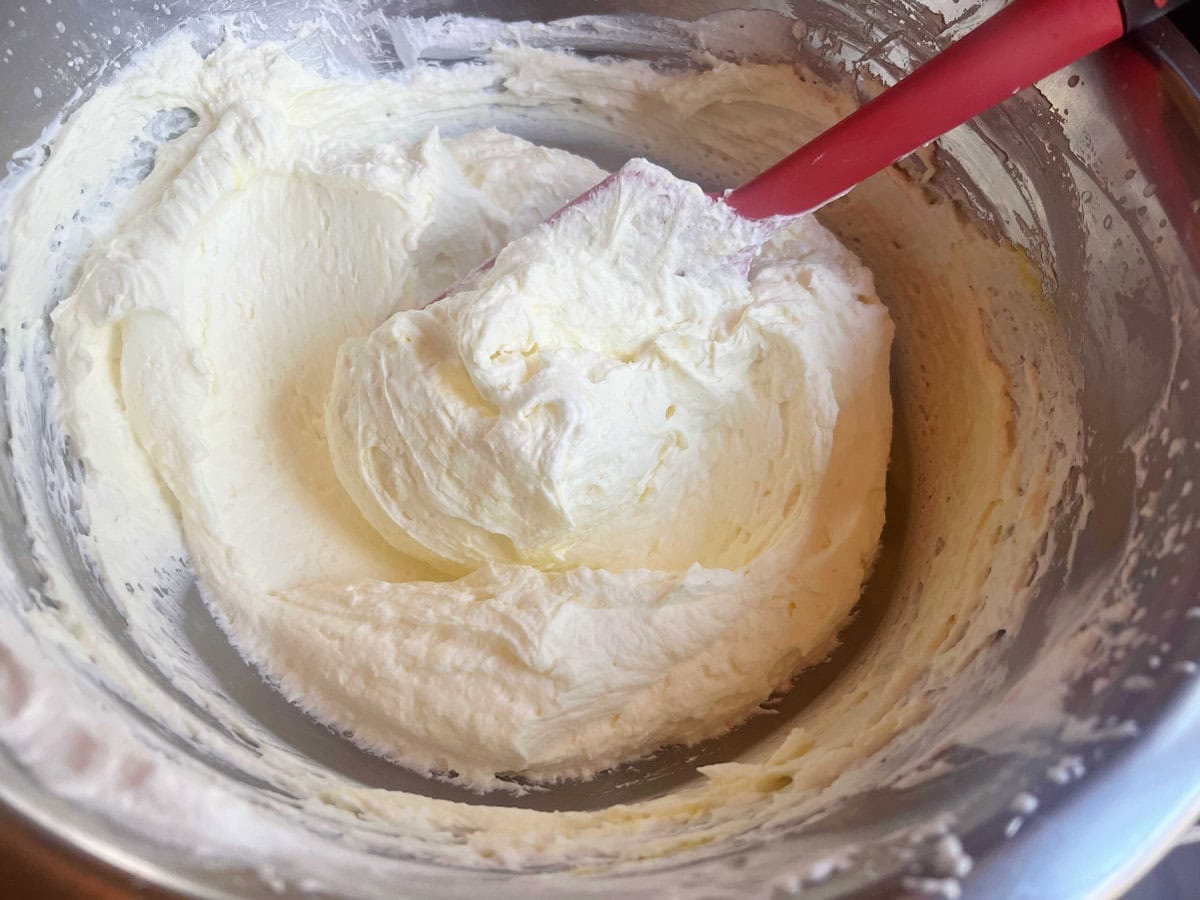 Combining the whipped cream with cream cheese mixture.