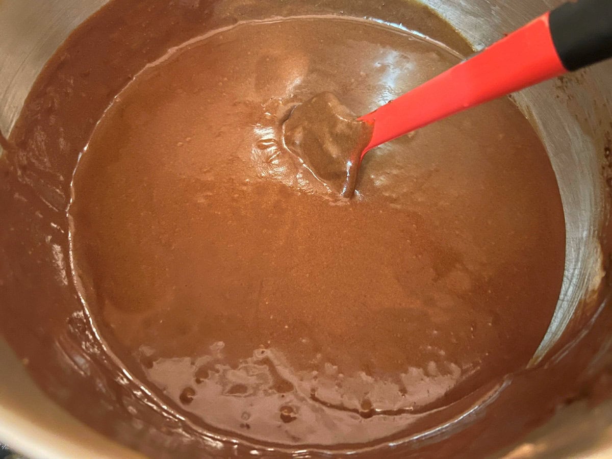 Thin chocolate cake batter in mixing bowl.