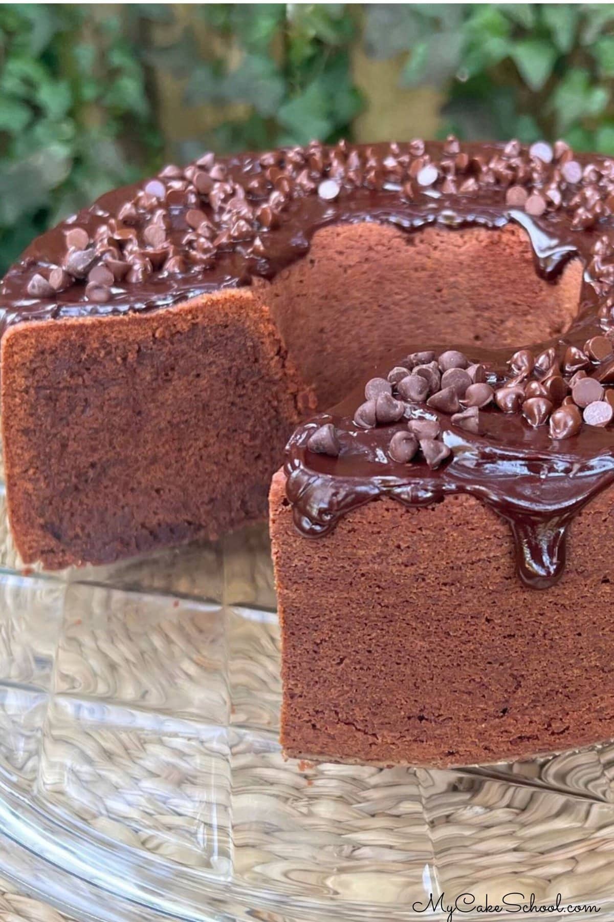 Chocolate Sour Cream Pound Cake, sliced, on a cake pedestal.