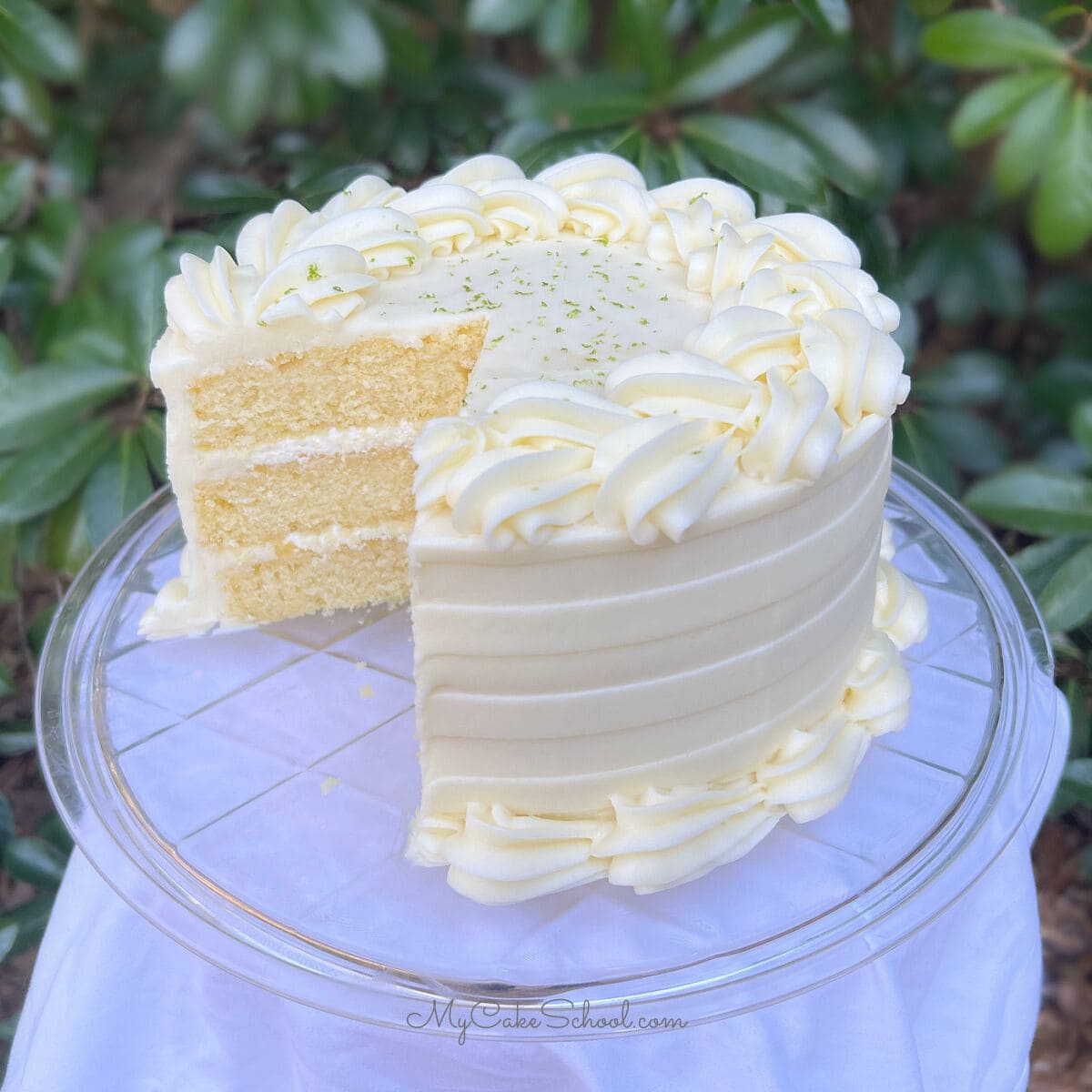 Key Lime Cake, sliced, on a cake pedestal.