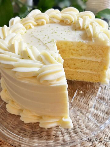 Key Lime Cake, sliced, on a cake platter.