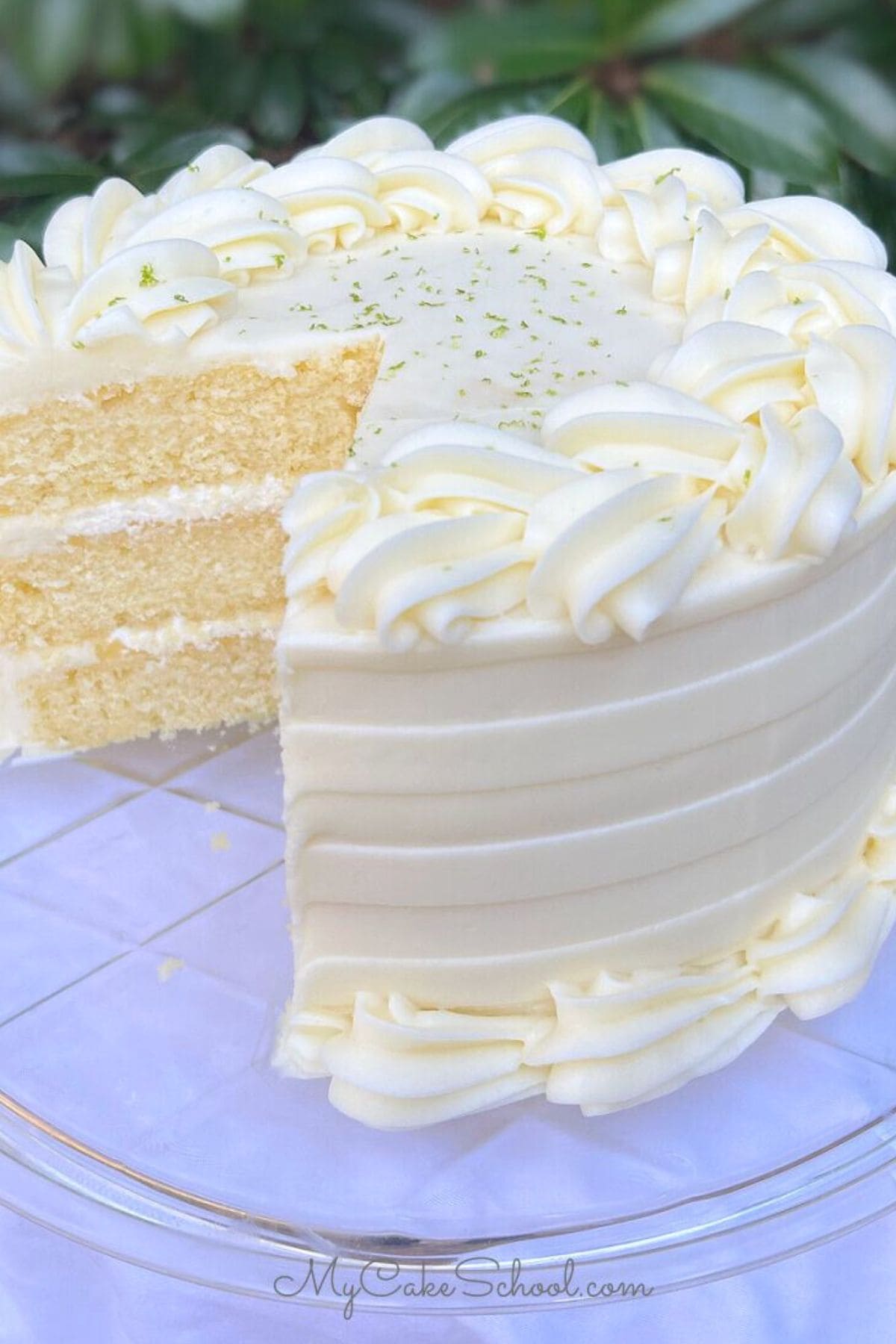 Key Lime Cake, sliced, on a pedestal.