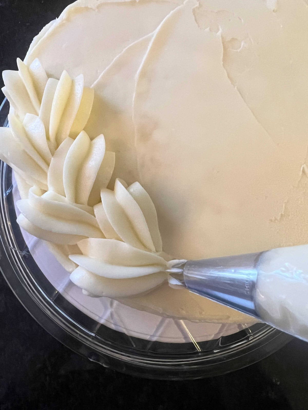 Piping borders onto the Key Lime Cake